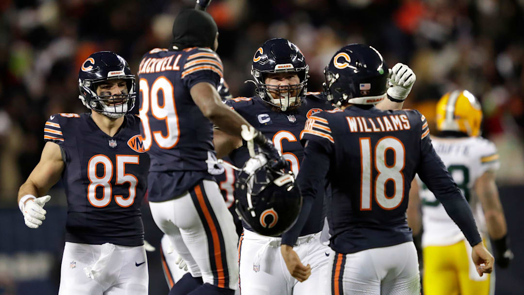 Bears quarterback Caleb Williams is swarmed by teammates after throwing the game-winning touchdown pass in overtime against Green Bay in Week 16.