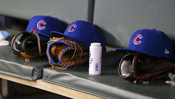 Apr 3, 2019; Atlanta, GA, USA; Detailed view of Chicago Cubs hats and gloves in the dugout against the Atlanta Braves in the fifth inning at SunTrust Park.