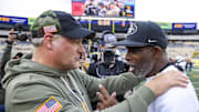 Nov 8, 2025; Morgantown, West Virginia, USA; West Virginia Mountaineers head coach Rich Rodriguez talks with Colorado Buffaloes head coach Deion Sanders after the game at Milan Puskar Stadium.