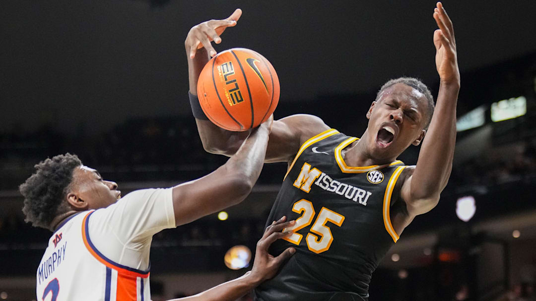 Jan 14, 2026; Columbia, Missouri, USA; Auburn Tigers forward Keshawn Murphy (3) fouls Missouri Tigers guard Mark Mitchell (25) while he’s shooting during the first half of the game at Mizzou Arena. Mandatory Credit: Denny Medley-Imagn Images