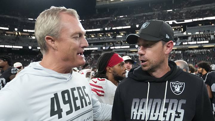 San Francisco 49ers president of football operations John Lynch (left) chats with Las Vegas Raiders head coach Klint Kubiak (right)