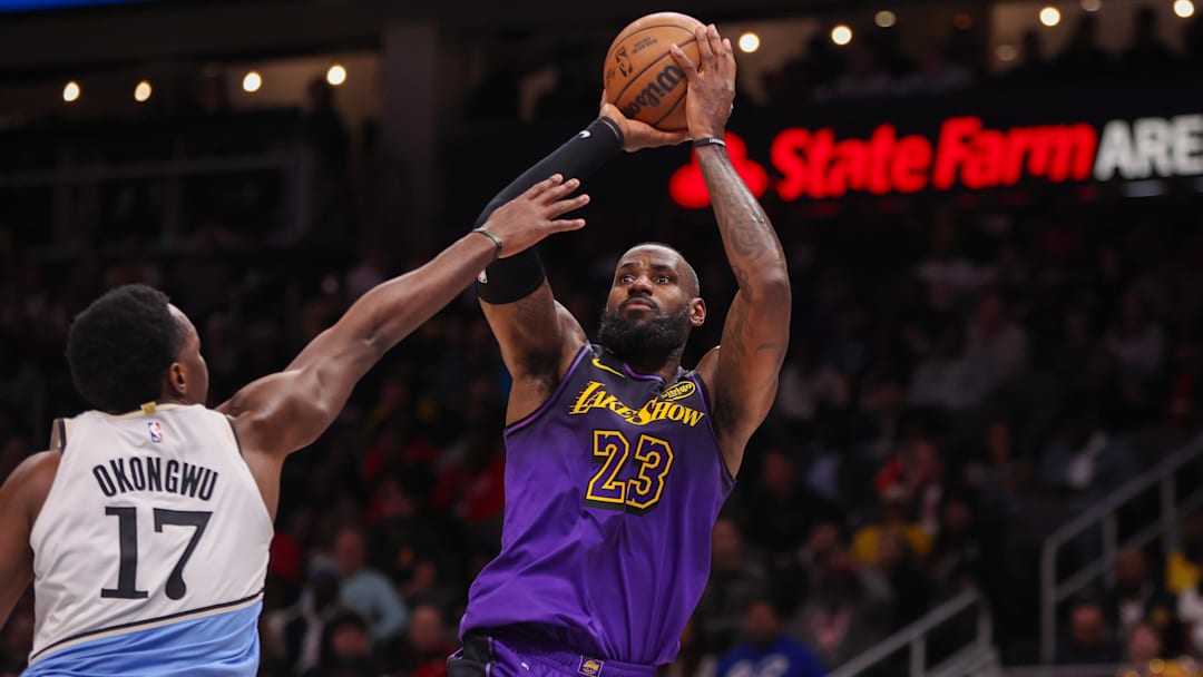 Dec 6, 2024; Atlanta, Georgia, USA; Los Angeles Lakers forward LeBron James (23) shoots over Atlanta Hawks forward Onyeka Okongwu (17) in the second quarter at State Farm Arena. Mandatory Credit: Brett Davis-Imagn Images