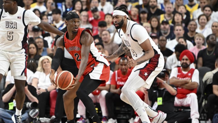 Jul 10, 2024; Las Vegas, Nevada, USA; Canada guard Shai Gilgeous-Alexander (2) looks to make a pass against USA forward Anthony Davis (14) in the first quarter in the USA Basketball Showcase at T-Mobile Arena. Mandatory Credit: Candice Ward-USA TODAY Sports