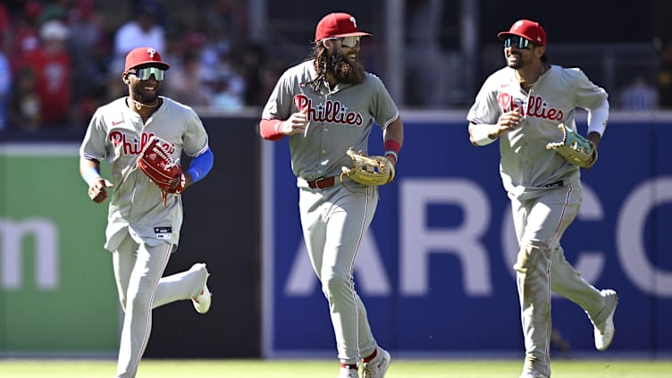 Apr 28, 2024; San Diego, California, USA; Philadelphia Phillies center fielder Johan Rojas (left) runs off the field alongside left fielder Brandon Marsh (center) and right fielder Nick Castellanos (right) after defeating the San Diego Padres at Petco Park. Mandatory Credit: Orlando Ramirez-USA TODAY Sports