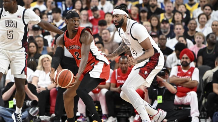 Jul 10, 2024; Las Vegas, Nevada, USA; Canada guard Shai Gilgeous-Alexander (2) looks to make a pass against USA forward Anthony Davis (14) in the first quarter in the USA Basketball Showcase at T-Mobile Arena. Mandatory Credit: Candice Ward-USA TODAY Sports