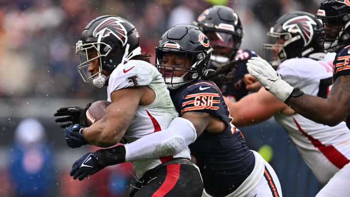 Dec 31, 2023; Chicago, Illinois, USA; Chicago Bears linebacker Tremaine Edmunds (49) wraps up Atlanta Falcons running back Bijan Robinson (7) for no gain in the first half at Soldier Field. Mandatory Credit: Jamie Sabau-USA TODAY Sports