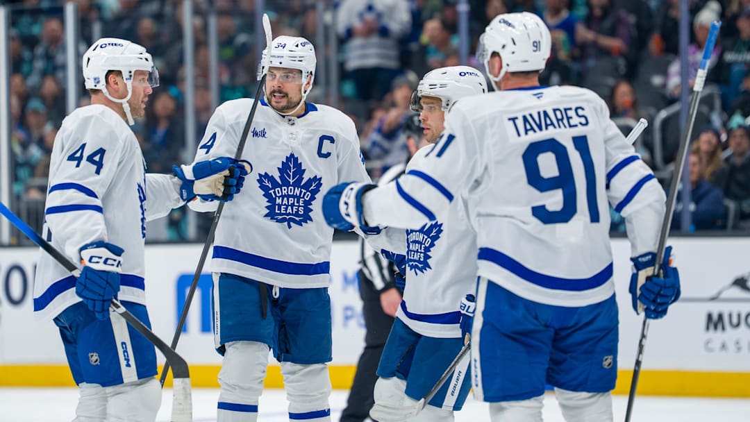 Jan 29, 2026; Seattle, Washington, USA; Toronto Maple Leafs, from left, defenseman Morgan Rielly (44), forward Auston Matthews (34), forward Max Domi (11) and forward John Tavares (91) celebrate a goal during the third period at Climate Pledge Arena. Mandatory Credit: Stephen Brashear-Imagn Images