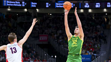 Mar 23, 2025; Seattle, WA, USA;  Oregon Ducks center Nate Bittle (32) attempts a 3-point shot against Arizona Wildcats forward Henri Veesaar (13) in the first half at Climate Pledge Arena. Mandatory Credit: Steven Bisig-Imagn Images
