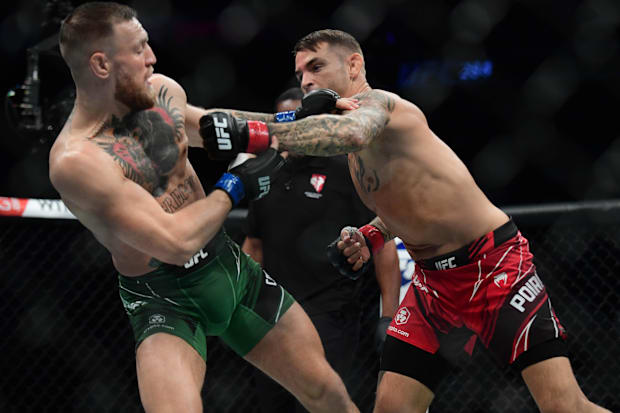 Dustin Poirier moves in for a hit as Conor McGregor defends during UFC 264 at T-Mobile Arena. 