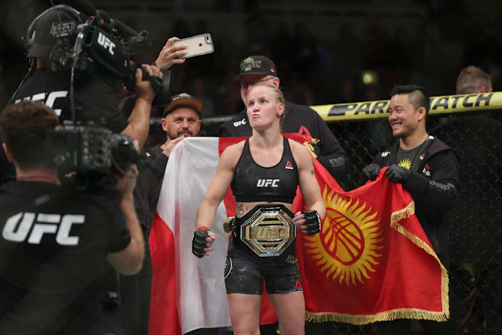 UFC champion Valentina Shevchenko celebrates with the championship belt after defeating Jessica Eye.