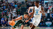 Michigan State Spartans guard Jeremy Fears Jr. (1) drives to the basket as North Carolina Tar Heels forward Caleb Wilson (8) guards him during the second half of the Fort Myers Tip-Off Beach Division game at Suncoast Credit Union Arena on Fort Myers, Fla., on Thursday, Nov. 27, 2025.