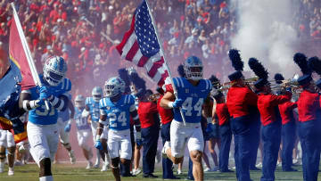 Oct 1, 2022; Oxford, Mississippi, USA; Mississippi Rebels line backer John Porchivina (44) carries the American flag out as he leads the team onto the field prior to the game against the Kentucky Wildcats at Vaught-Hemingway Stadium. Mandatory Credit: Petre Thomas-USA TODAY Sports