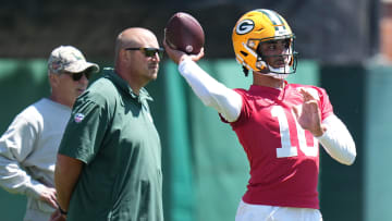 As Green Bay Packers offensive coordinator Adam Stenavich looks on, quarterback Jordan Love (10) throws a pass during organized team activities Wednesday, May 29, 2024 in Green Bay, Wisconsin.