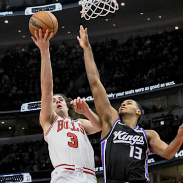 Jan 12, 2025; Chicago, Illinois, USA;  Chicago Bulls guard Josh Giddey (3) shoots against Sacramento Kings forward Keegan Murray (13) during the first half at United Center. Mandatory Credit: Matt Marton-Imagn Images