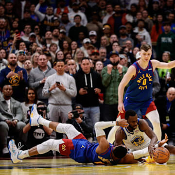Dec 3, 2024; Denver, Colorado, USA; Golden State Warriors forward Andrew Wiggins (22) battles for for a loose ball with Denver Nuggets guard Russell Westbrook (4) as guard Christian Braun (0) and forward Jonathan Kuminga (00) and guard Jamal Murray (27) look on in the fourth quarter at Ball Arena. Mandatory Credit: Isaiah J. Downing-Imagn Images