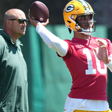 As Green Bay Packers offensive coordinator Adam Stenavich looks on, quarterback Jordan Love (10) throws a pass during organized team activities Wednesday, May 29, 2024 in Green Bay, Wisconsin.