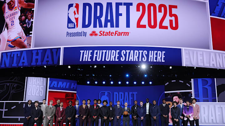 The 2025 NBA Draft class and NBA commissioner Adam Silver stand on stage. The 2025 NBA Draft class and NBA commissioner Adam Silver stand on stage.