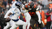 Dec 7, 2025; Cleveland, Ohio, USA; Cleveland Browns linebacker Carson Schwesinger (49) sacks Tennessee Titans quarterback Cam Ward (1) during the third quarter at Huntington Bank Field. Mandatory Credit: Scott Galvin-Imagn Images