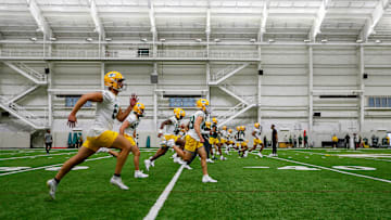 Green Bay Packers players warm up during rookie minicamp on Friday at the Don Hutson Center.