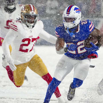 Dec 1, 2024; Orchard Park, New York, USA; Buffalo Bills running back Ray Davis (22) runs with the ball against San Francisco 49ers safety Ji'Ayir Brown (27) during the second half at Highmark Stadium. Mandatory Credit: Gregory Fisher-Imagn Images