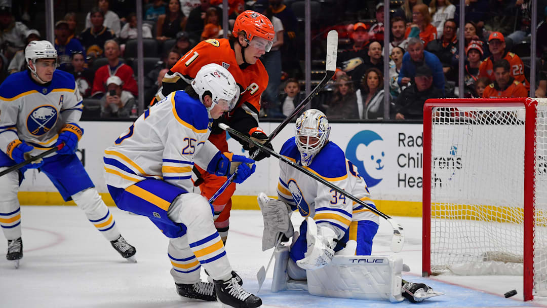 Mar 22, 2026; Anaheim, California, USA; Anaheim Ducks center Leo Carlsson (91) misses his shot wide as Buffalo Sabres defenseman Owen Power (25) helps goaltender Alex Lyon (34) defend the goal during the overtime period at Honda Center. Mandatory Credit: Gary A. Vasquez-Imagn Images