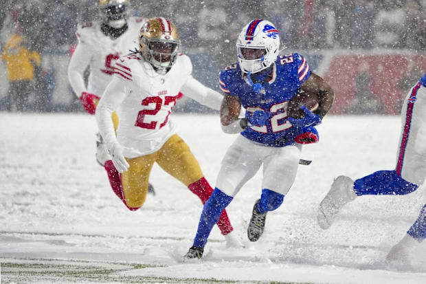 Buffalo Bills running back Ray Davis (22) runs with the ball against San Francisco 49ers safety Ji'Ayir Brown (27) during the