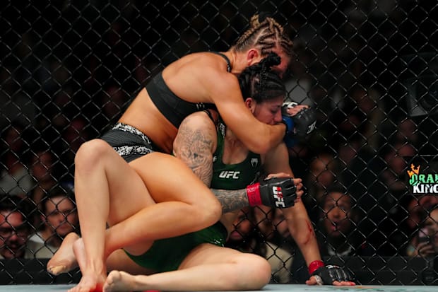 Ketlen Vieira (red gloves) fights Kayla Harrison (blue gloves) during UFC 307 at Delta Center. 