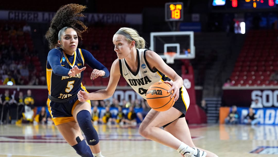 Iowa's Kylie Feuerbach (4) drives to the basket as Murray State's Trinity White (5) defends during first half of the first round of the NCAA Women's college basketball game between Iowa and Murray State at the Lloyd Noble Center in Norman, Okla., Saturday, March, 22, 2025.