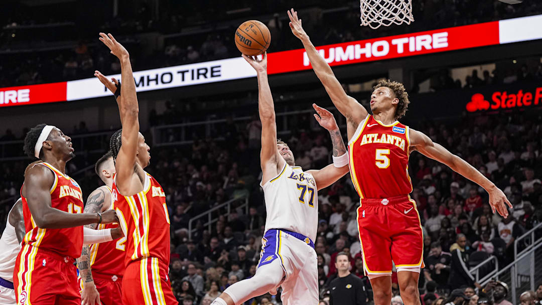Nov 8, 2025; Atlanta, Georgia, USA; Los Angeles Lakers guard Luka Doncic (77) shoots against Atlanta Hawks guard Dyson Daniels (5)  during the first half at State Farm Arena. Mandatory Credit: Dale Zanine-Imagn Images