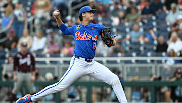 Jun 19, 2024; Omaha, NE, USA;  Florida Gators starting pitcher Liam Peterson (12) throws against the Texas A&M Aggies during the first inning at Charles Schwab Field Omaha. Mandatory Credit: Steven Branscombe-Imagn Images