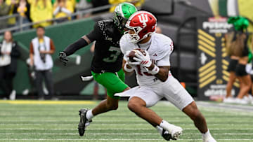 Oct 11, 2025; Eugene, Oregon, USA; Indiana Hoosiers wide receiver Elijah Sarratt (13) runs with the ball against Oregon Ducks defensive back Sione Laulea (3) during the second quarter at Autzen Stadium. 