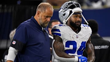 Dallas Cowboys running back Miles Sanders (24) walks off the field with team staff during the game between the Dallas Cowboys and the Green Bay Packers at AT&T Stadium.