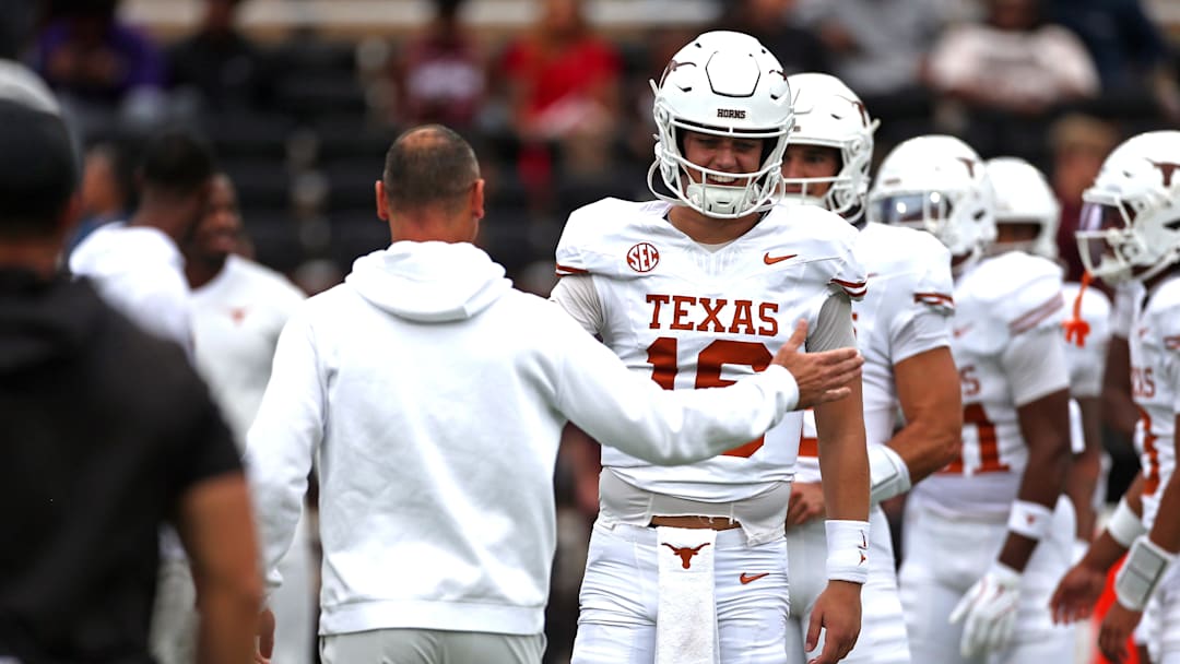 Texas Longhorns quarterback Arch Manning with head coach Steve Sarkisian during warm-ups before the game against the Mississippi State Bulldogs at Davis Wade Stadium at Scott Field.