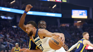 Minnesota Timberwolves' center Rudy Gobert battles against Golden State Warriors' forward Draymond Green