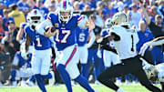 Buffalo Bills quarterback Josh Allen runs for a gain past New Orleans Saints cornerback Alontae Taylor.