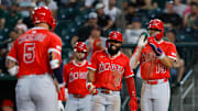 May 20, 2025; West Sacramento, California, USA; Los Angeles Angels second baseman Luis Rengifo (2) smiles as third baseman Yoán Moncada (5) runs the bases after hitting a three run home run during the fifth inning against the Athletics at Sutter Health Park. Mandatory Credit: Sergio Estrada-Imagn Images