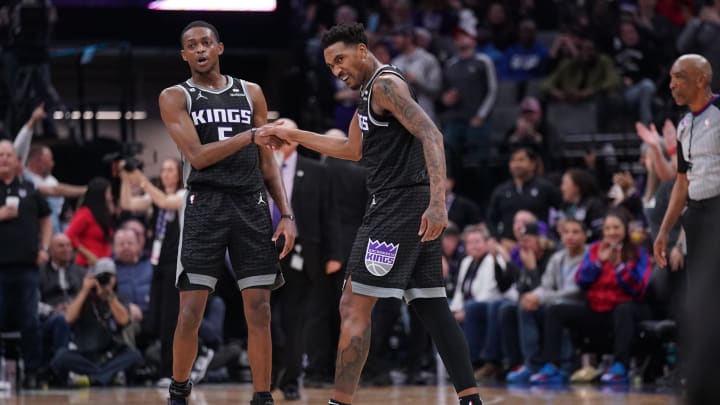 Jan 23, 2023; Sacramento, California, USA; Sacramento Kings guard Malik Monk (0) is congratulated by guard De'Aaron Fox (5) after dunking the ball against the Memphis Grizzlies in the fourth quarter at the Golden 1 Center. Mandatory Credit: Cary Edmondson-USA TODAY Sports