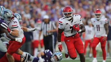 Arizona Wildcats running back Quali Conley (7) runs the ball during the first quarter of the game against Kansas State at Bill Snyder Family Stadium Friday, September 13, 2024.