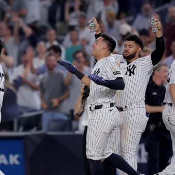 Jul 10, 2025; Bronx, New York, USA; New York Yankees designated hitter Aaron Judge (99) celebrates with second baseman Jazz Chisholm Jr. (13) and shortstop Anthony Volpe (11) and left fielder Jasson Dominguez (24) after his tenth inning walkoff sacrifice fly against the Seattle Mariners at Yankee Stadium. Mandatory Credit: Brad Penner-Imagn Images