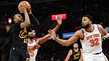 Feb 21, 2025; Cleveland, Ohio, USA;  Cleveland Cavaliers guard Darius Garland (10) shoots as New York Knicks center Karl-Anthony Towns (32) defends during the second half at Rocket Arena. Mandatory Credit: Ken Blaze-Imagn Images