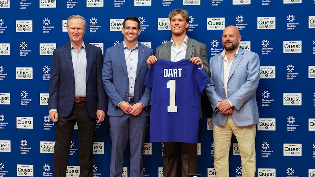 Apr 25, 2025; East Rutherford, NJ, US; New York Giants president John Mara (far left), general manager Joe Schoen (left), Jaxson Dart, and head coach Brian Daboll (right) pose for photos prior to the start of the press conference to introduce the Giants first round draft picks.  Mandatory Credit: Thomas Salus-Imagn Images
