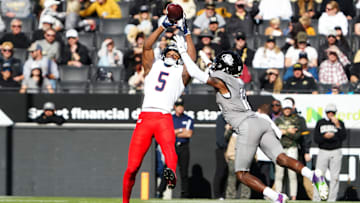 Nov 11, 2023; Boulder, Colorado, USA; Arizona Wildcats wide receiver Montana Lemonious-Craig (5) pulls in a reception against Colorado Buffaloes cornerback Travis Hunter (12) in the first half at Folsom Field. Mandatory Credit: Ron Chenoy-Imagn Images