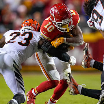 Kansas City Chiefs running back Isiah Pacheco (10) leans into a tackle from Cincinnati Bengals safety Dax Hill (23) in the fourth quarter of the NFL Week 17 game between the Kansas City Chiefs and the Cincinnati Bengals at Arrowhead Stadium in Kansas City, Mo., on Sunday, Dec. 31, 2023. The Chiefs won 25-17 to clinch the AFC West Championship.