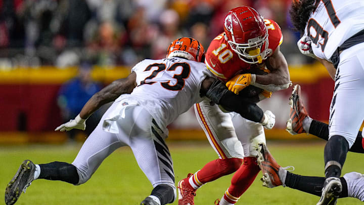 Kansas City Chiefs running back Isiah Pacheco (10) leans into a tackle from Cincinnati Bengals safety Dax Hill (23) in the fourth quarter of the NFL Week 17 game between the Kansas City Chiefs and the Cincinnati Bengals at Arrowhead Stadium in Kansas City, Mo., on Sunday, Dec. 31, 2023. The Chiefs won 25-17 to clinch the AFC West Championship.