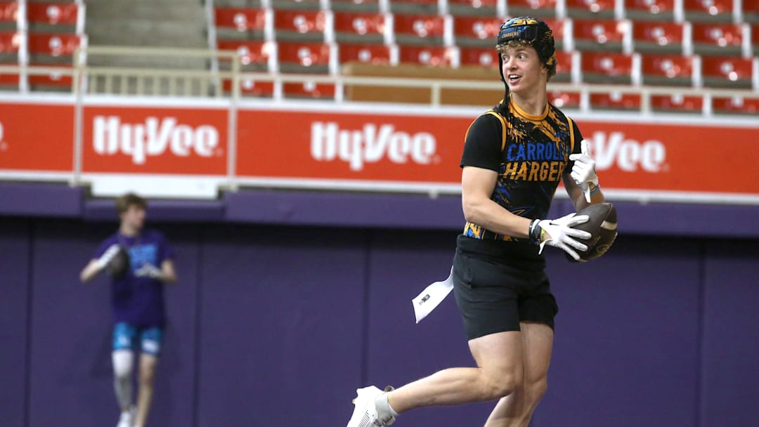 The Carroll Chargers’ Jaxx DeJean warms up before a 7-on-7 football tournament game Saturday, April 13, 2024 at the UNI Dome in Cedar Falls, Iowa.