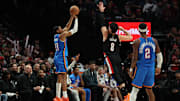 Nov 5, 2025; Portland, Oregon, USA;  Oklahoma City Thunder guard Aaron Wiggins (21) shoots the ball over Portland Trail Blazers forward Deni Avdija (8) during the second half at Moda Center. Mandatory Credit: Jaime Valdez-Imagn Images