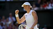 Iga Swiatek celebrates winning Wimbledon.