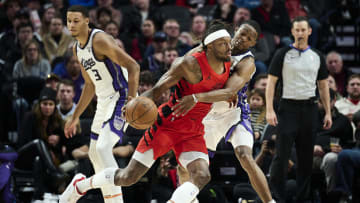 Dec 26, 2023; Portland, Oregon, USA; Sacramento Kings guard De'Aaron Fox (5) reaches in during the first half against Portland Trail Blazers forward Jerami Grant (9) at Moda Center. Mandatory Credit: Troy Wayrynen-USA TODAY Sports