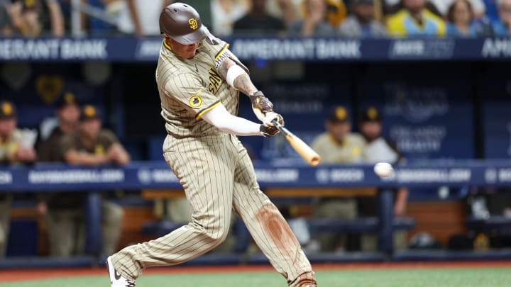 Aug 30, 2024; St. Petersburg, Florida, USA; San Diego Padres designated hitter Manny Machado (13) hits a single against the Tampa Bay Rays in the sixth inning at Tropicana Field. Mandatory Credit: Nathan Ray Seebeck-USA TODAY Sports