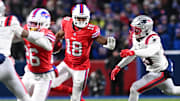 Dec 22, 2024; Orchard Park, New York, USA; Buffalo Bills wide receiver Amari Cooper (18) stiff arms New England Patriots linebacker Christian Elliss (53) in the second quarter at Highmark Stadium. 
